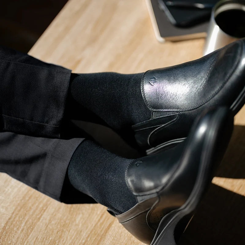 close up detail photos of Amberjack Dress Socks in Obsidian paired with The Slip-On Obsidian and black dress pants