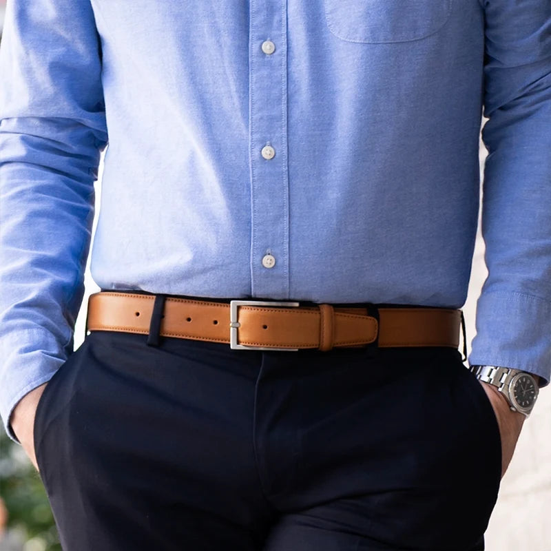 Amberjack Full-Grain Belt in Honey - on model wearing blue dress shirt and dark blue dress pants