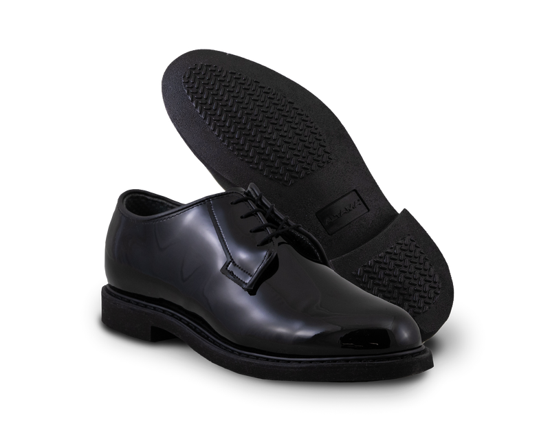 2 black gloss leather shoes sit beside each other showing sole and top of shoe
