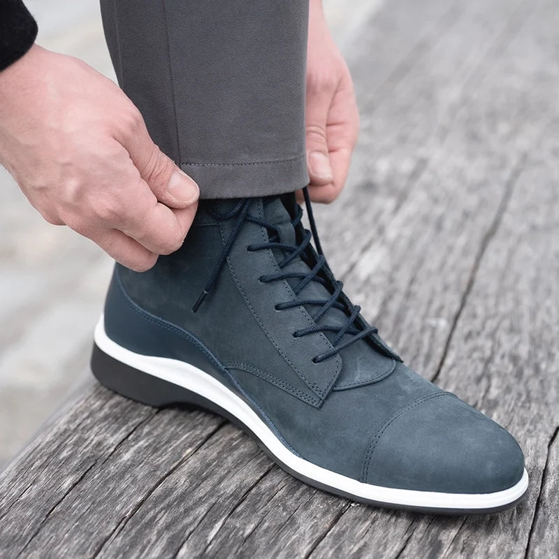 model wearing The Boot in Cobalt blue Nubuck by Amberjack wearing gray pants