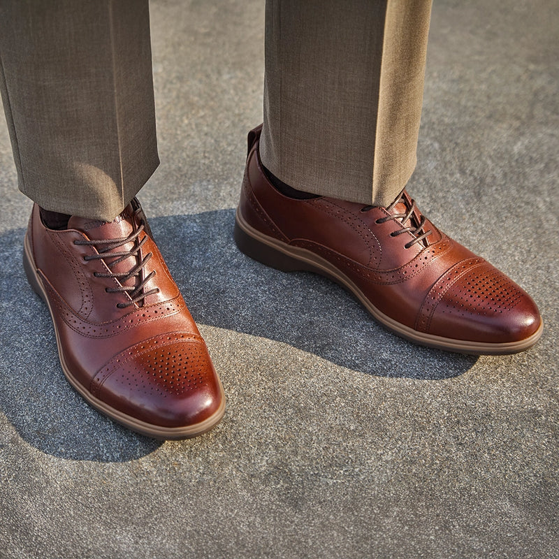 The Cap-Toe in Chestnut Brown Leather worn by model in light brown dress pants