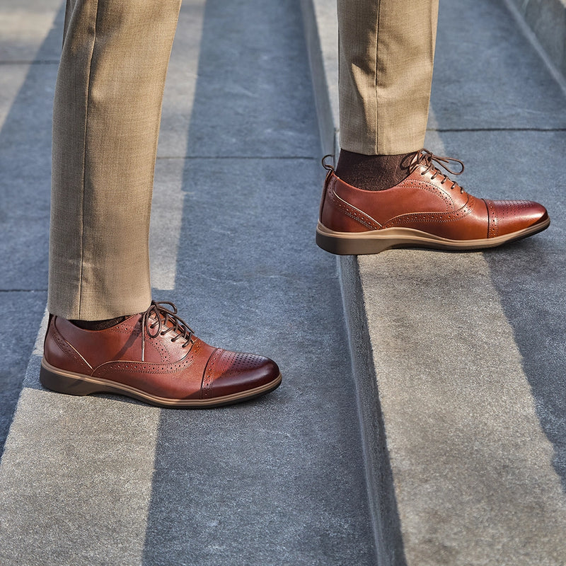Detail photo of The Cap-Toe in Chestnut Brown worn by model on stairs