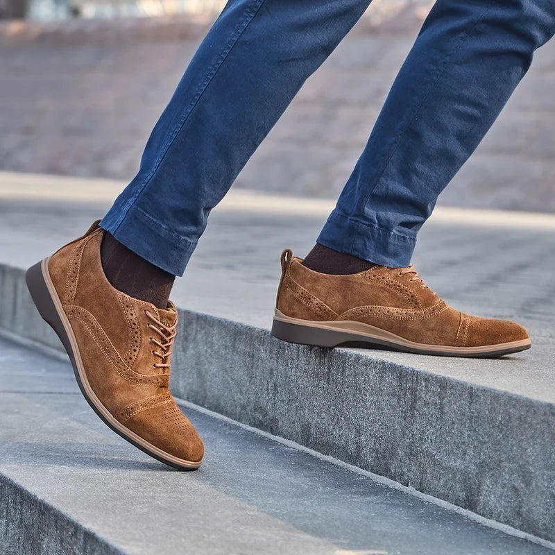Model wearing The Cap-Toe Grizzly paired with navy pants