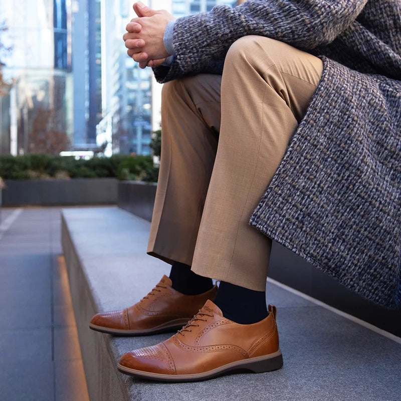 The Cap-Toe in Honey Tan Leather worn by model in light tan dress pants