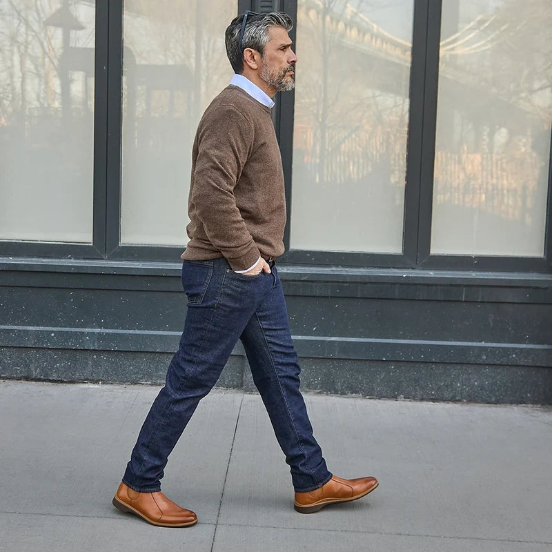 model walking in the chelsea honey with dark jeans and dark sweater