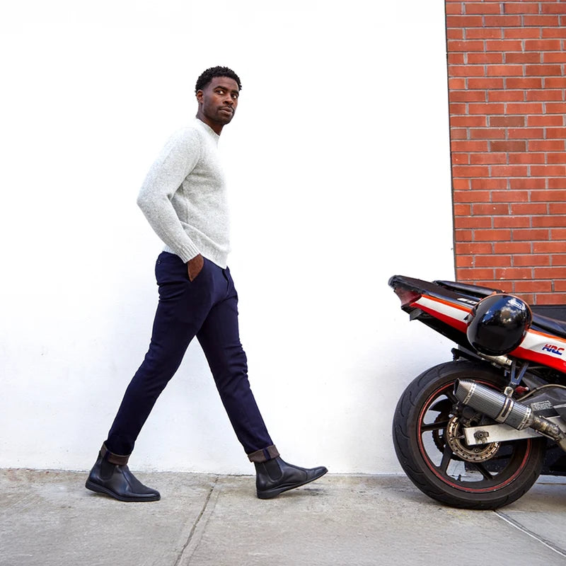 model walking in the chelsea obsidian paired with dark blue pants and light sweater