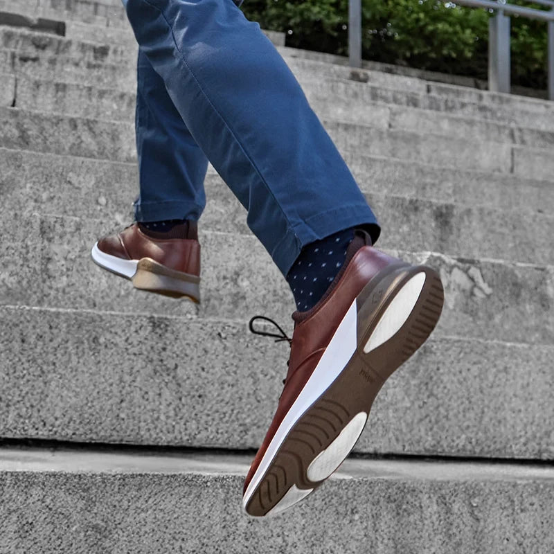 The Hybrid in Chestnut Brown Leather - on model running up stairs