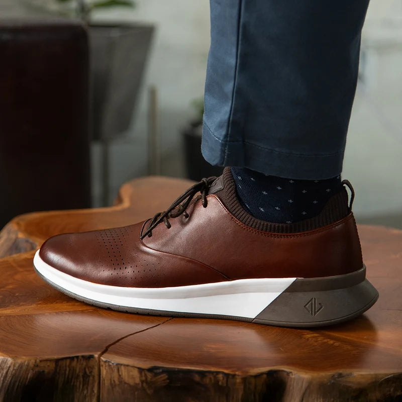 The Hybrid in Chestnut Brown Leather - on model wearing blue pants