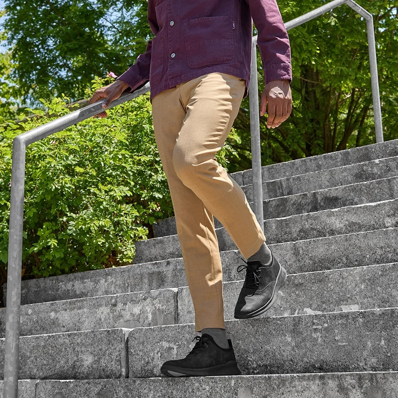The Hybrid in Midnight Black Nubuck by Amberjack - on model walking down stairs in khakis pants