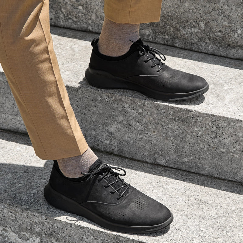 The Hybrid in Midnight Black Nubuck by Amberjack - on model sitting down in khakis pants