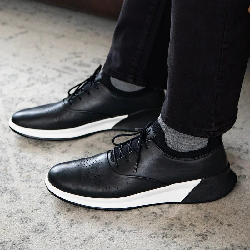 The Hybrid  in Obsidian Black by Amberjack - on model sitting down wearing black jeans