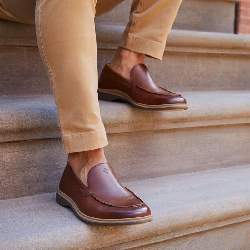 The Loafer in Chestnut Brown by Amberjack - On model sitting on stairs wearing tan pants