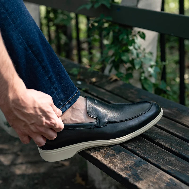 The Loafer by Amberjack in Obsidian & Cream Black Leather - close up on model wearing blue jeans