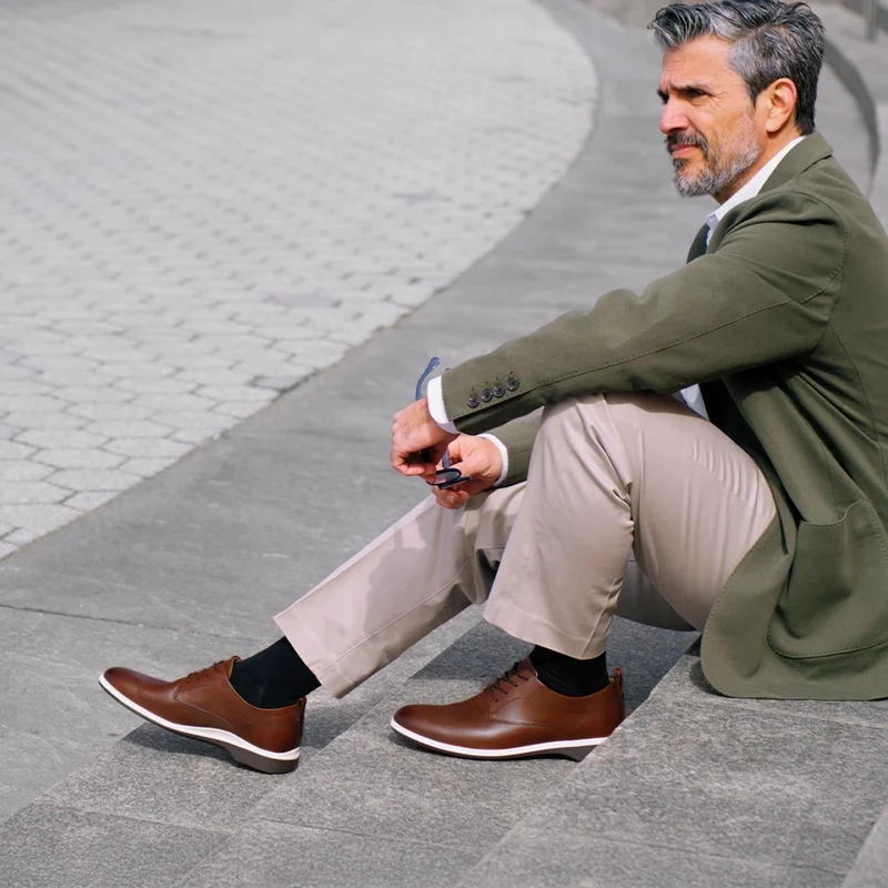 Model wearing The Original Coffee with green jacket and khaki pants