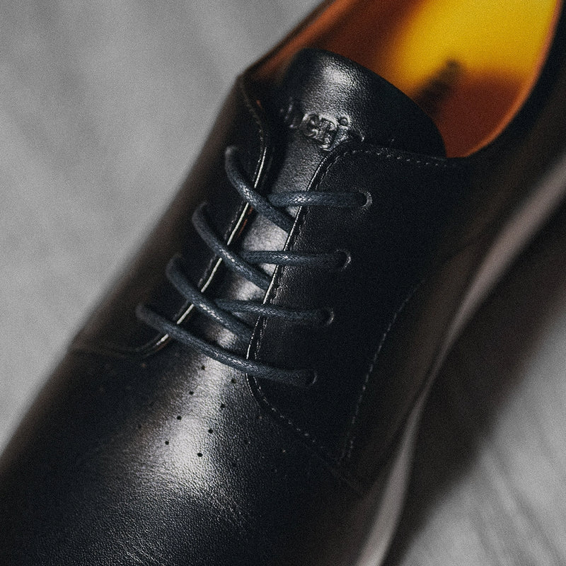 Close up detail photo of The Original Obsidian black leather and shoe laces