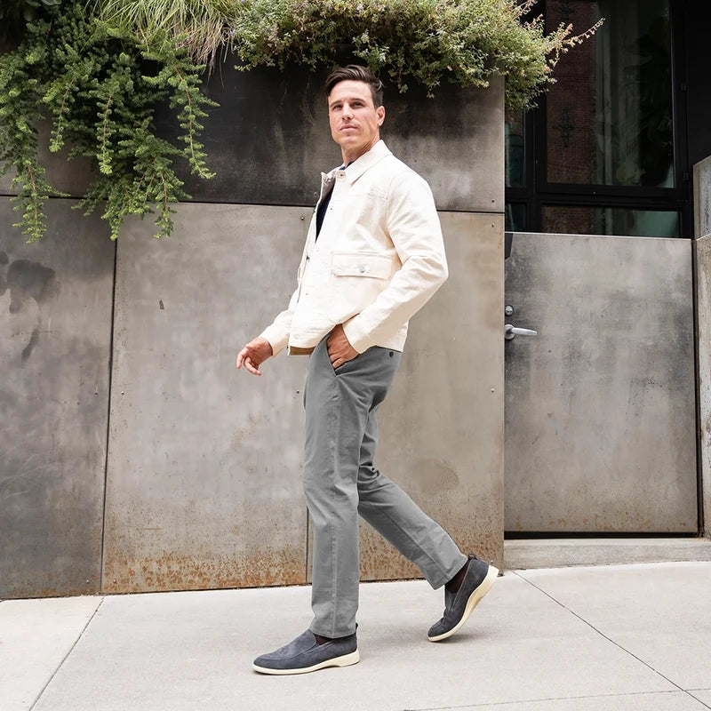 Model wearing The Slip-On Slate paired with gray pants and a light jacket