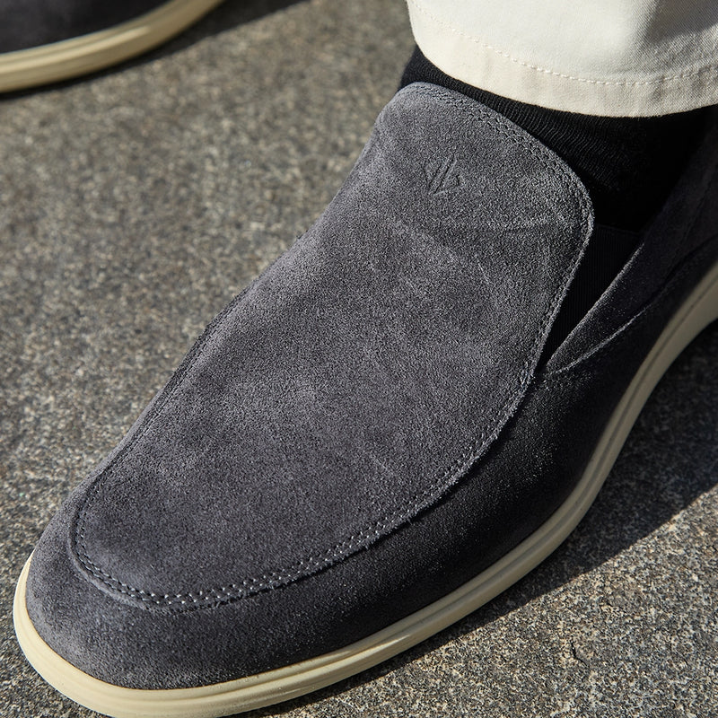 close up image of model wearing The Slip-On Carbon paired with black dress socks and dress pants