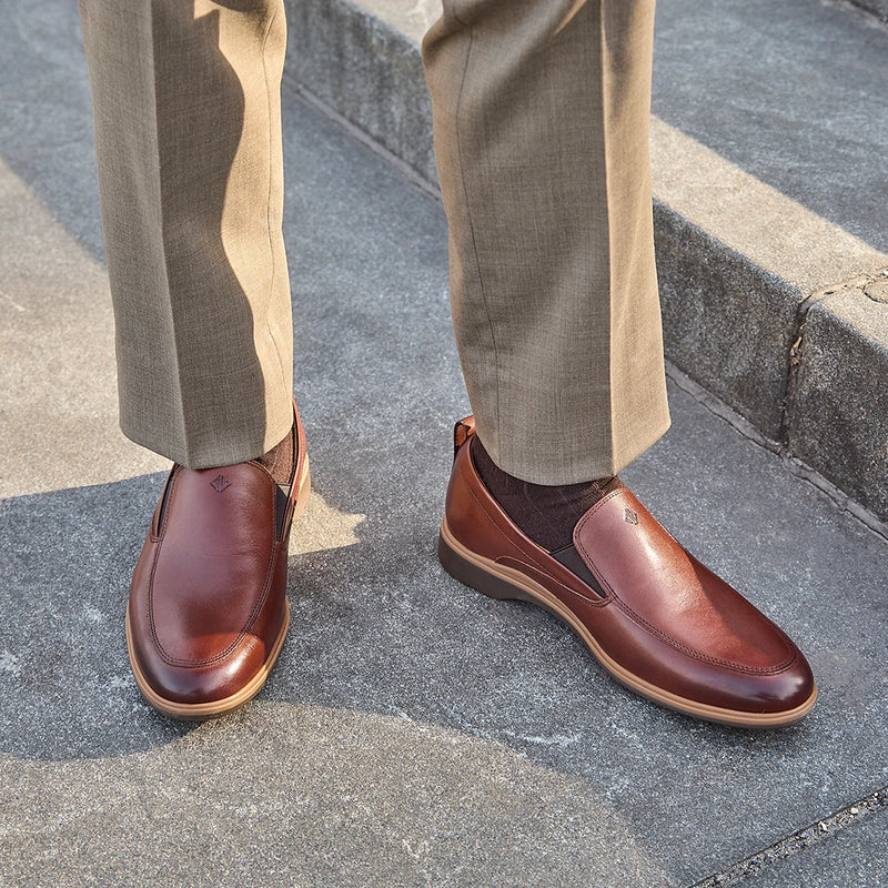 The Slip-On by Amberjack in Chestnut Leather - Worn with brown Dress Pants on model