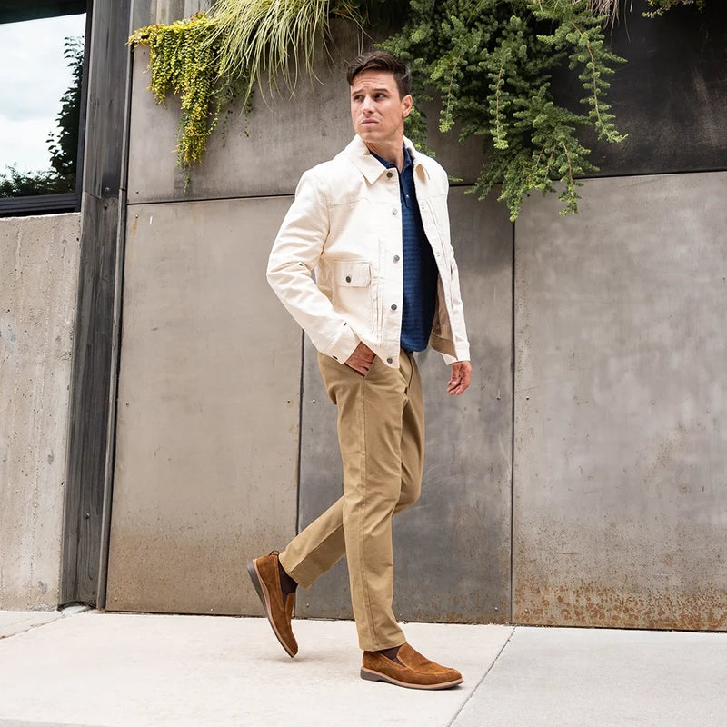 Model walking wearing The Slip On Grizzly paired with khaki pants