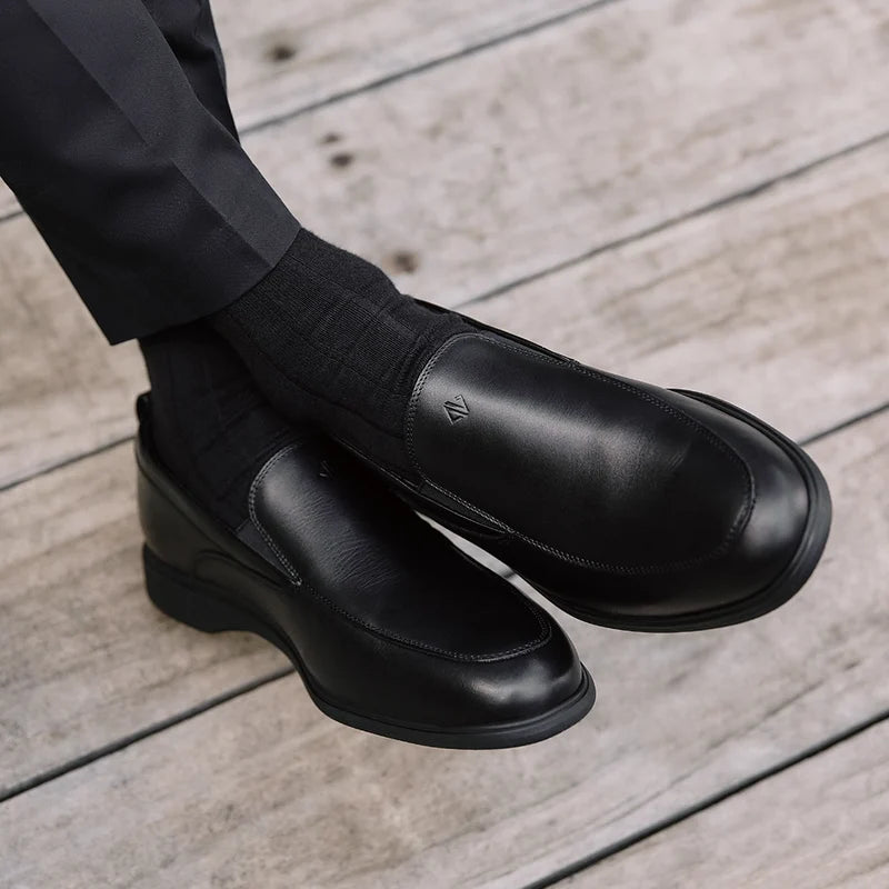 The Slip-On by Amberjack in Obsidian Leather - Worn with dark gray Dress Pants
