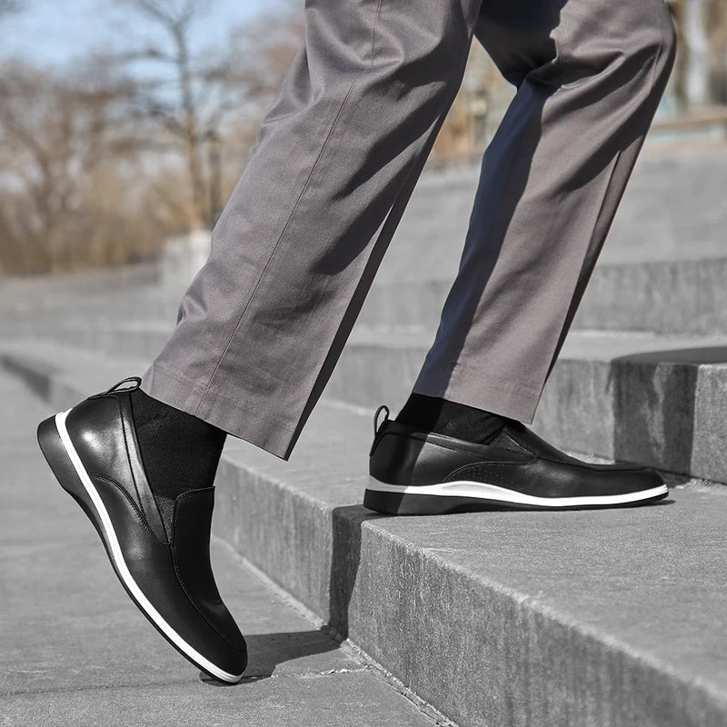 Model wearing The Slip-On Onyx paired with dark gray dress pants