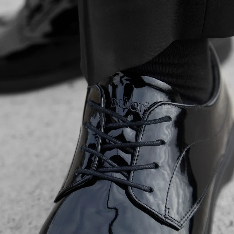 model wearing a Tuxedo with The Tux by Amberjack in Obsidian black patent leather - up close detail photo