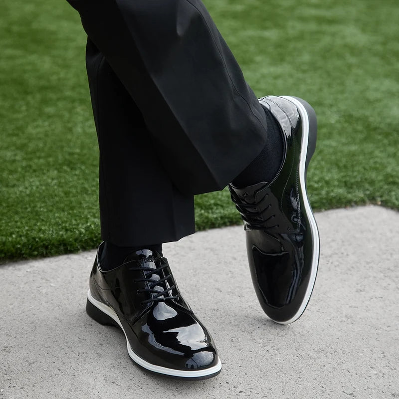 model wearing The Tux Onyx black and white patent leather shoe